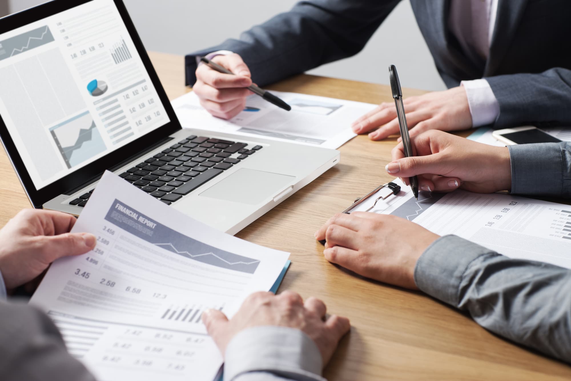 Accountants reviewing broker-dealer financial records